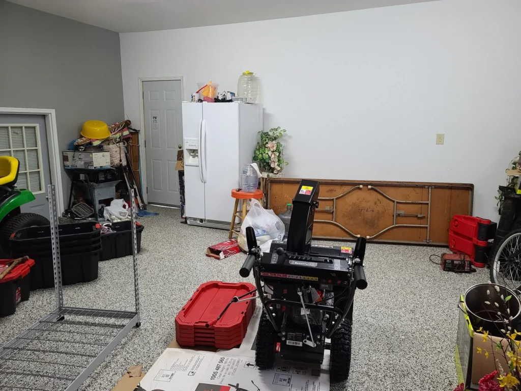 A cluttered garage with no room for cars.